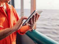 chief-officer-or-captain-on-deck-of-vessel-or-ship-watching-digital-tablet