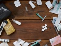 packs-of-powder-drugs-stuff-dollar-banknotes-and-synthetic-drugs-pills-medical-syringe