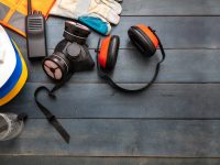 work-safety-protection-equipment-flat-lay-on-wooden-background-